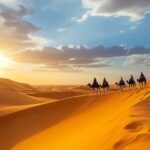 Camel caravan crossing the golden dunes of the Sahara Desert at sunset in Merzouga, Morocco