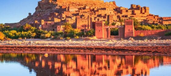 Ait Ben Haddou kasbah at sunset with reflections in the water, UNESCO World Heritage site in Morocco