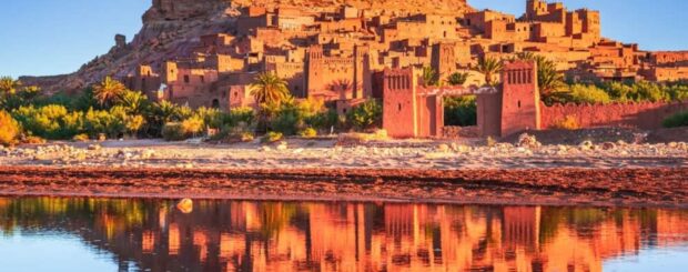 Ait Ben Haddou kasbah at sunset with reflections in the water, UNESCO World Heritage site in Morocco