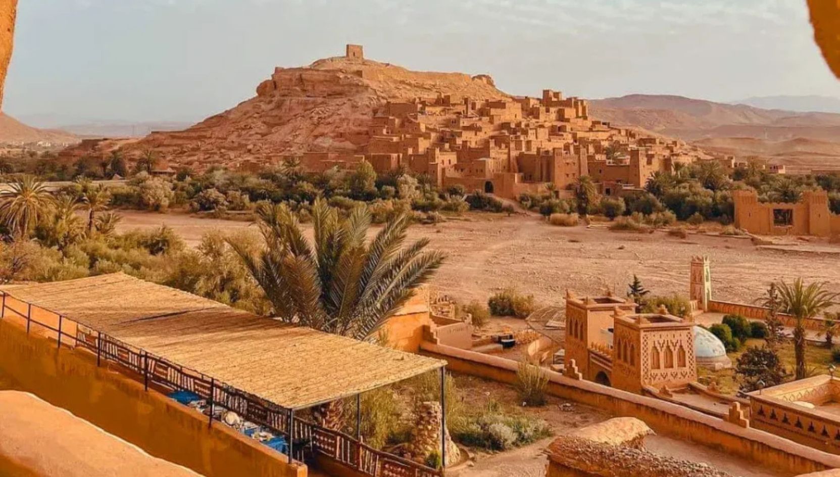 Panoramic view of Aït Ben Haddou Kasbah and the surrounding Ouarzazate desert landscape in southern Morocco.
