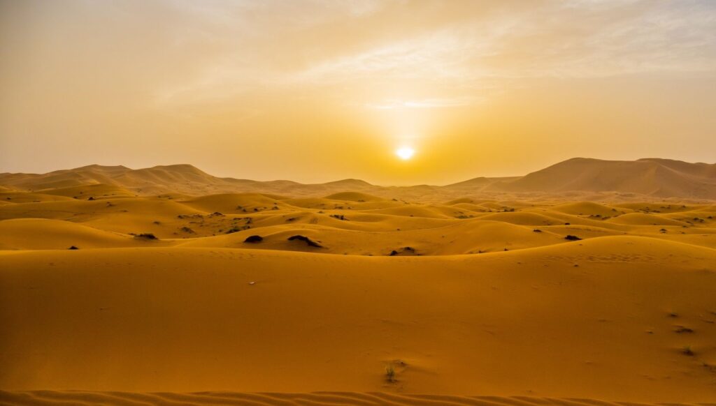 Golden sand dunes of Erg Chebbi at sunset in the Sahara Desert near Merzouga, Morocco.