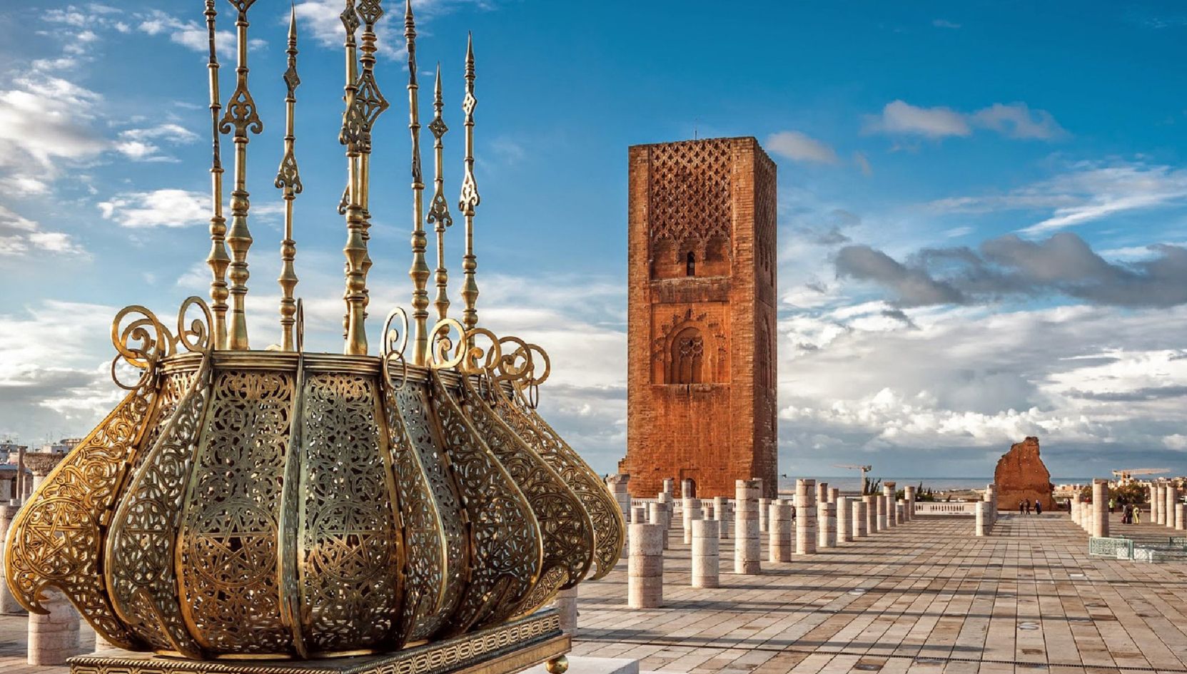 Decorative bronze lantern and Hassan Tower on the Mausoleum of Mohammed V esplanade in Rabat.