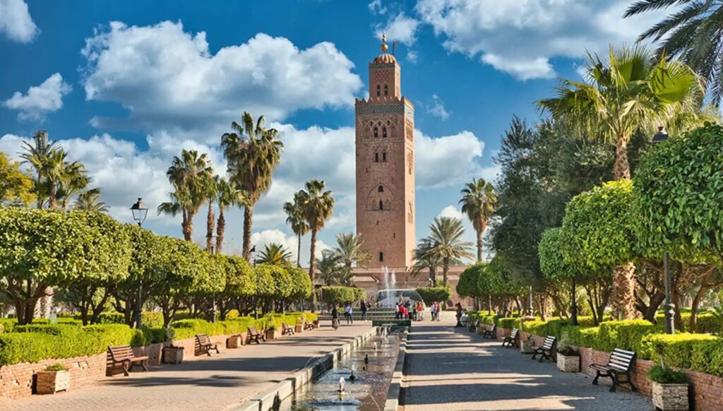 Koutoubia Mosque surrounded by palm trees and gardens in Marrakech, Morocco
