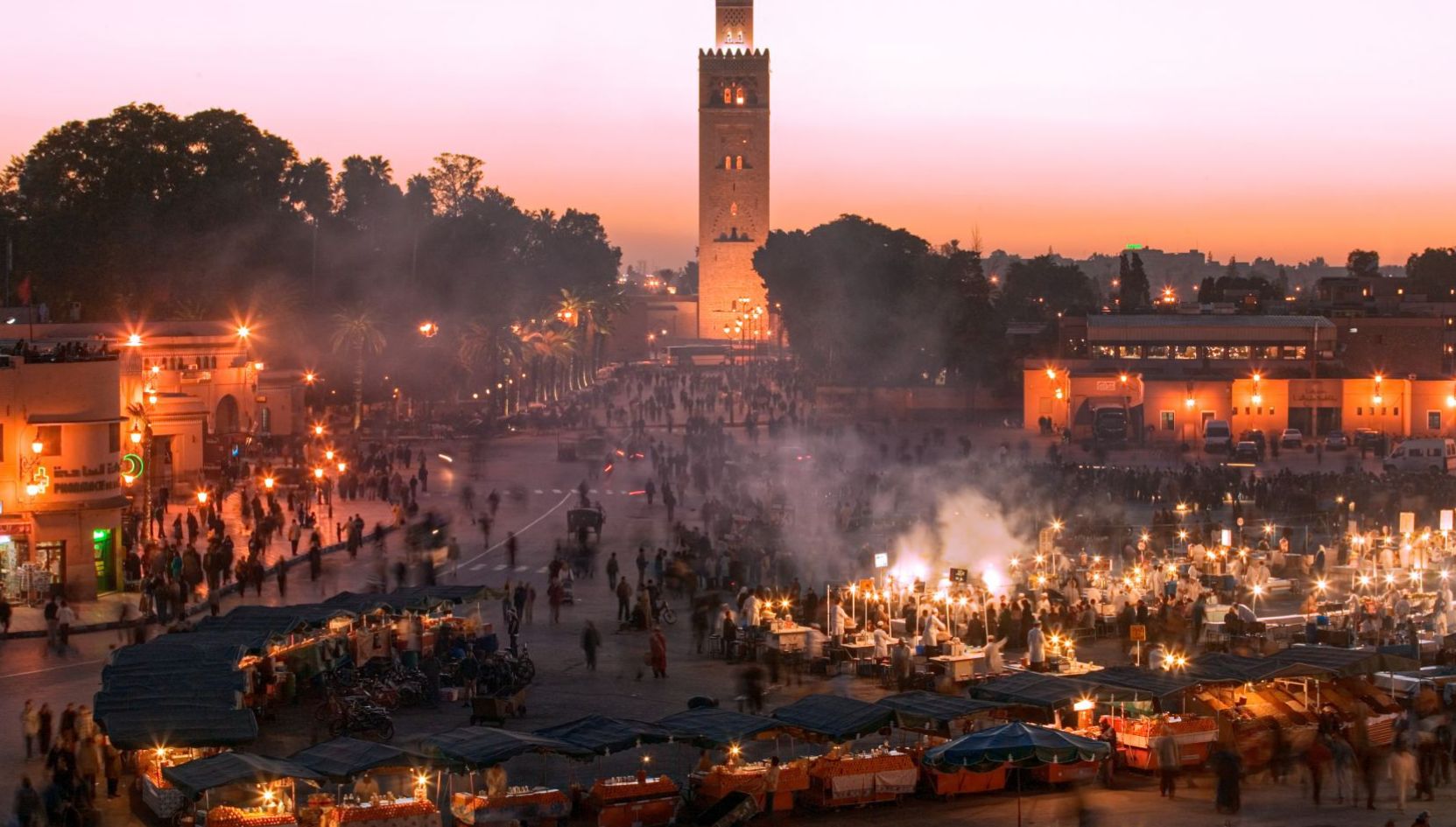 Jemaa el Fna square at sunset with the Koutoubia Mosque in Marrakech