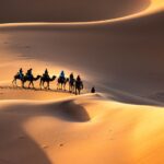 Camel caravan trekking through the golden dunes of Erg Chebbi at sunset in Merzouga, Morocco.