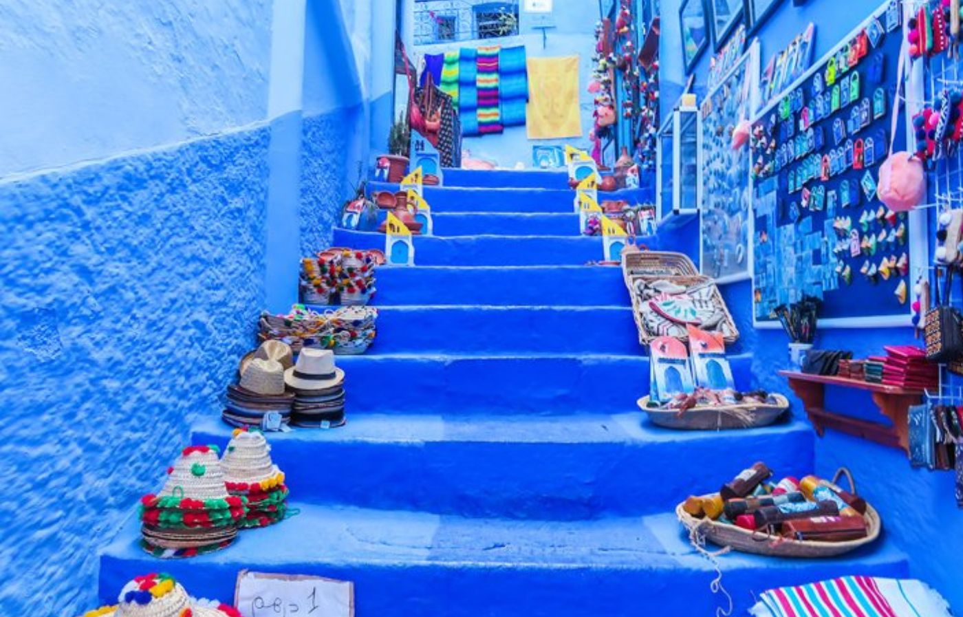 Blue-painted stairs in the medina of Chefchaouen with local handicrafts and souvenirs