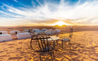 Luxury desert camp at sunrise in Merzouga, Chegaga, and Erg Chebbi with traditional seating on sand dunes